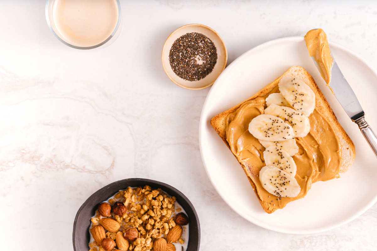 Toast Of Peanut Butter And Bowl Of Granola On A Kitchen Countertop