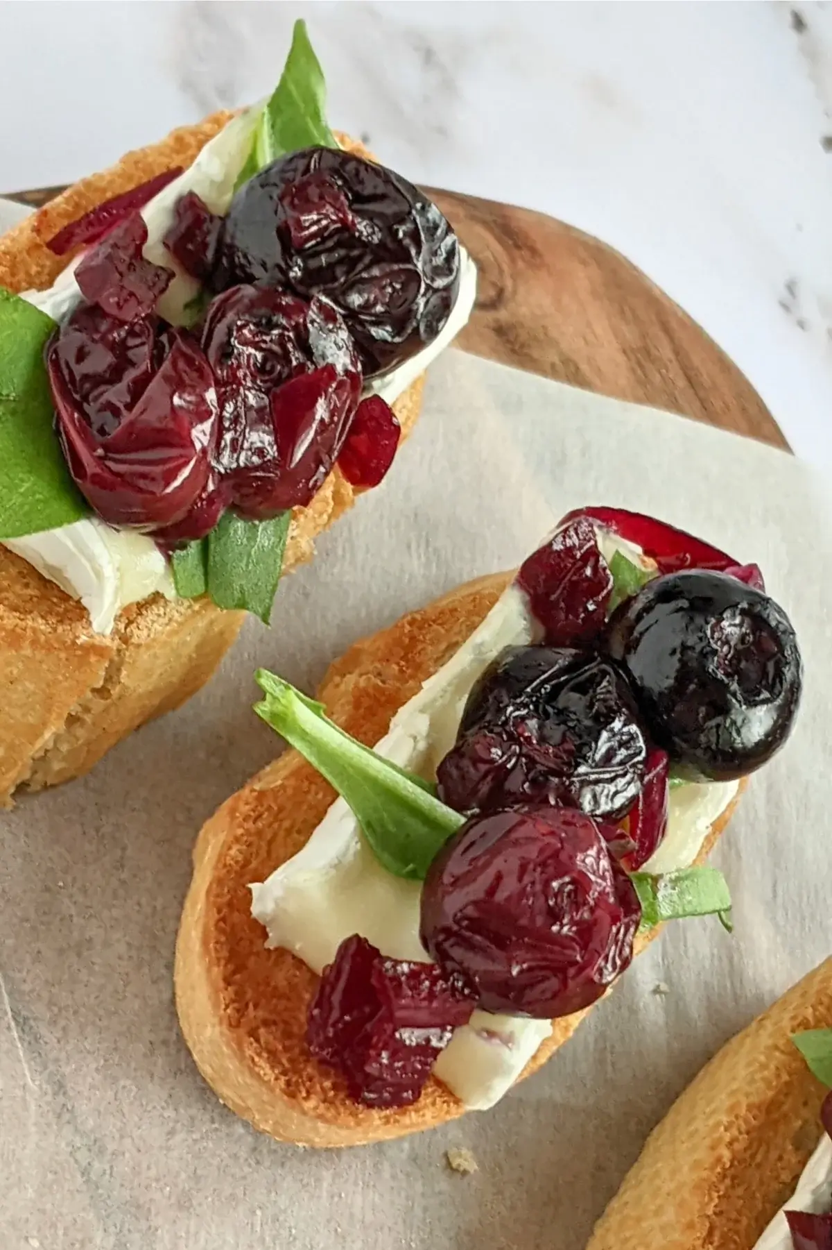 Blueberry crostini with Brie & arugula, layered with balsamic blueberries and arugula on toasted baguette slices.