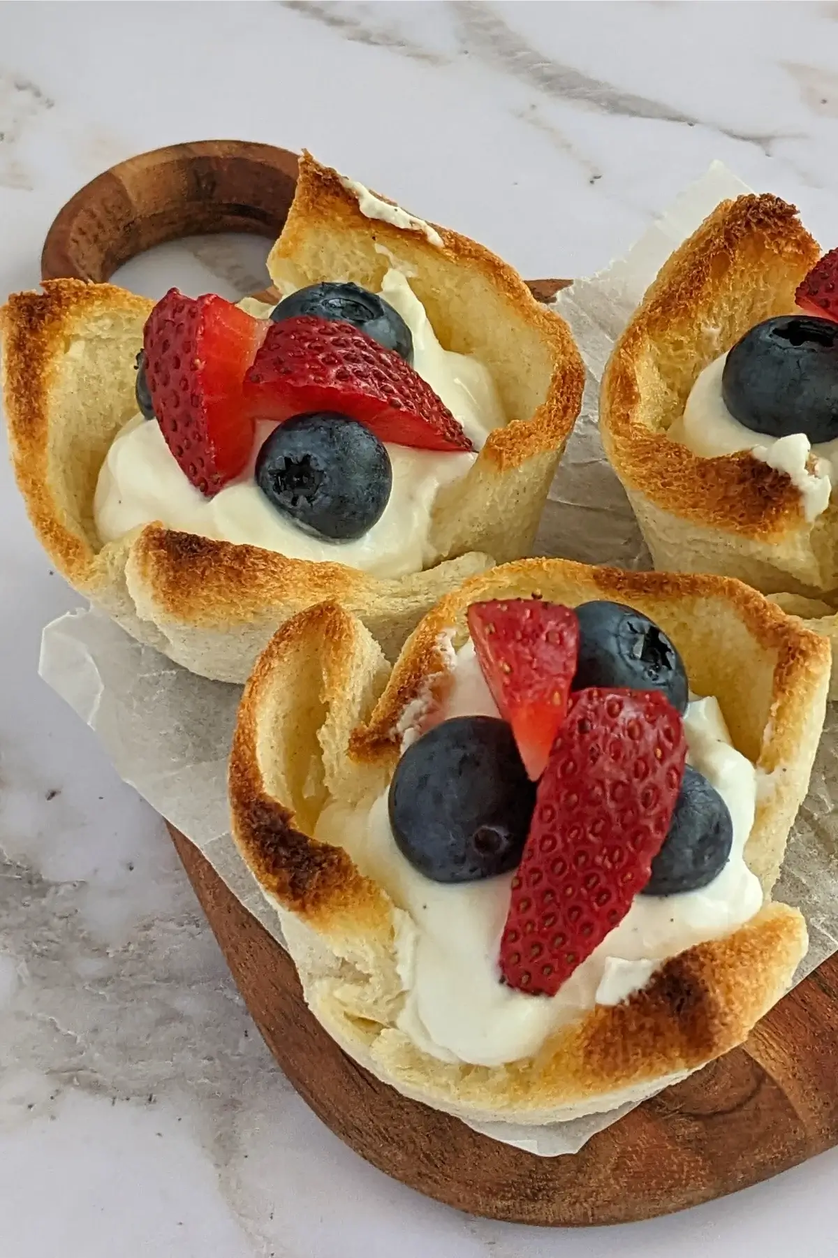 Red, white & blue bread cups made with white bread, filled with ricotta cheese and fresh berries.