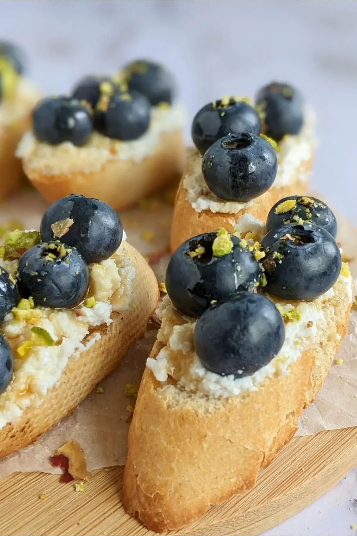 Toasted crostini topped with sweet ricotta and fresh blueberries for a simple yet elegant appetizer or dessert.