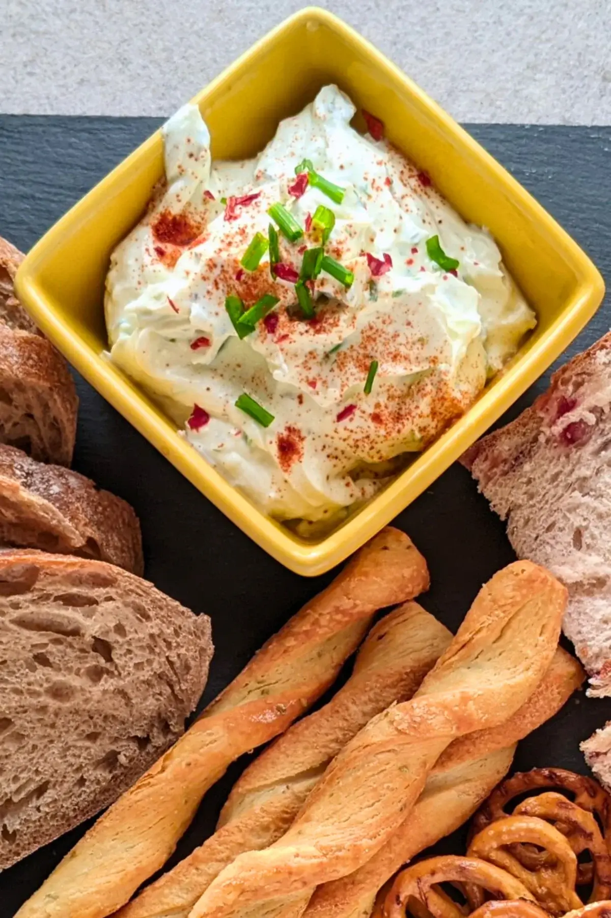 Healthy feta dip made with whipped feta and yogurt, served with crackers and puff pastry sticks.