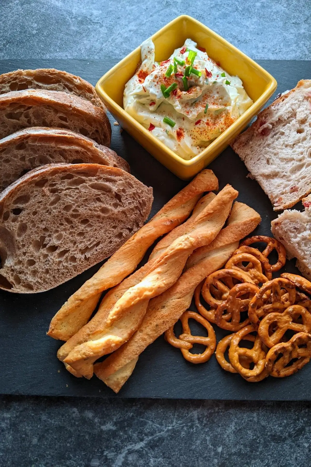 Whipped feta dip with Greek yogurt, chives, and lemon, served with crackers or bread for dipping.
