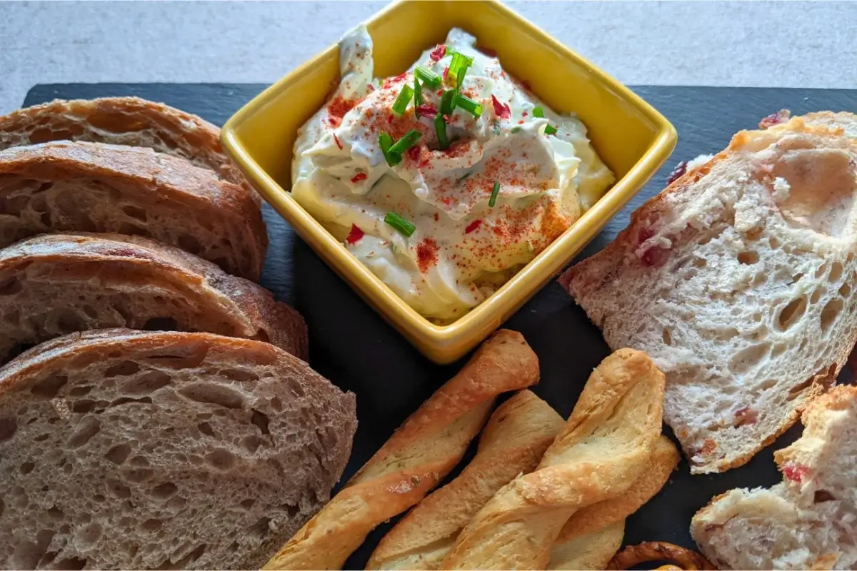 Whipped feta dip with Greek yogurt, chives, and lemon, served with crackers or bread for dipping.