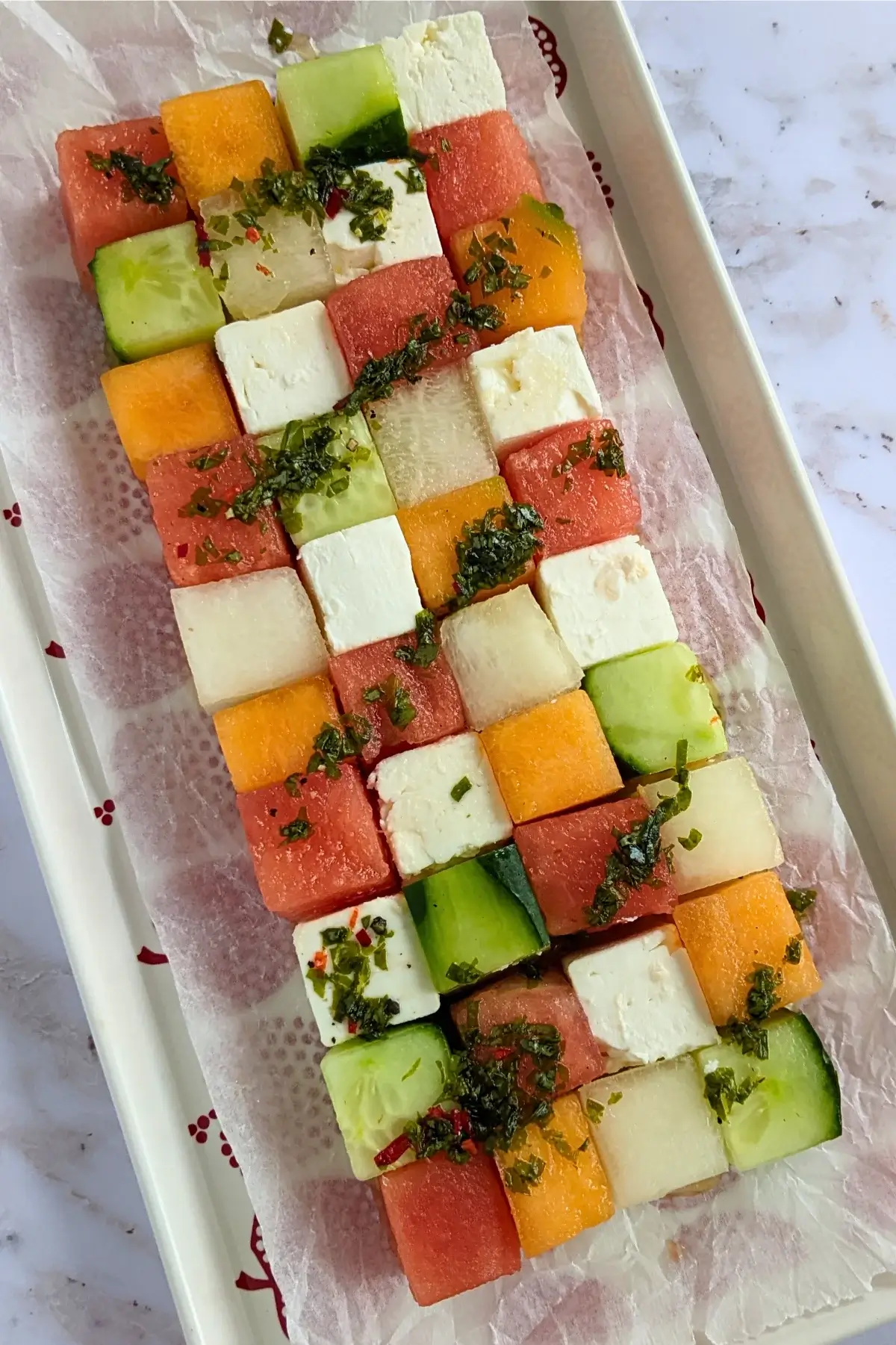 Tetris-style melon, cucumber, watermelon and feta salad drizzled with vinaigrette.