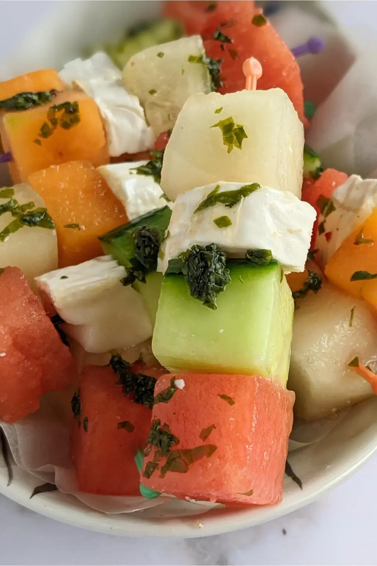Skewers of melon, watermelon, cucumber, and goat cheese drizzled with a refreshing mint vinaigrette.