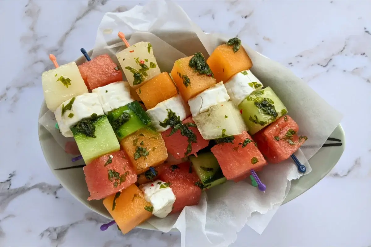 Skewers of melon, watermelon, cucumber, and goat cheese drizzled with a refreshing mint vinaigrette.