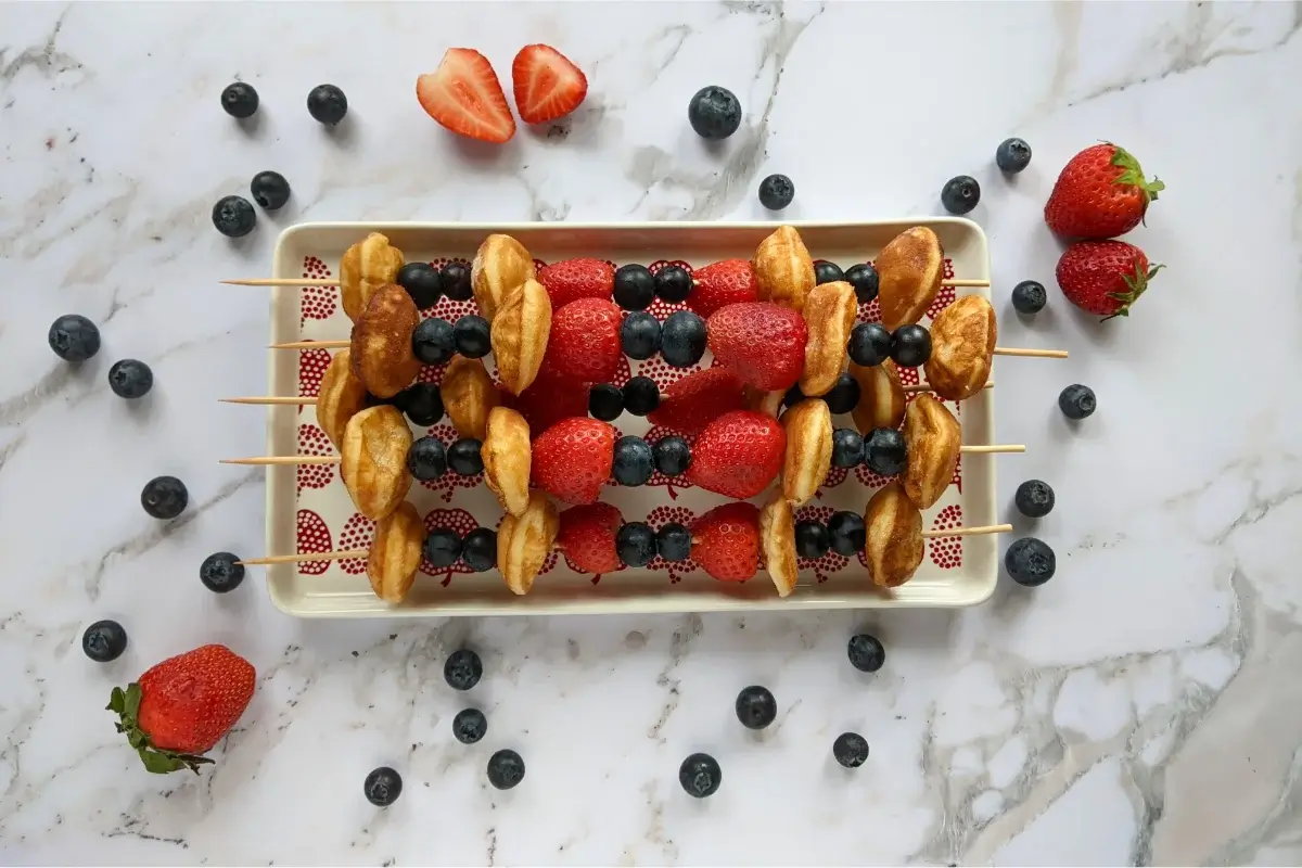 Mini pancakes and fresh berries skewered together for a colorful, kid-friendly summer snack.