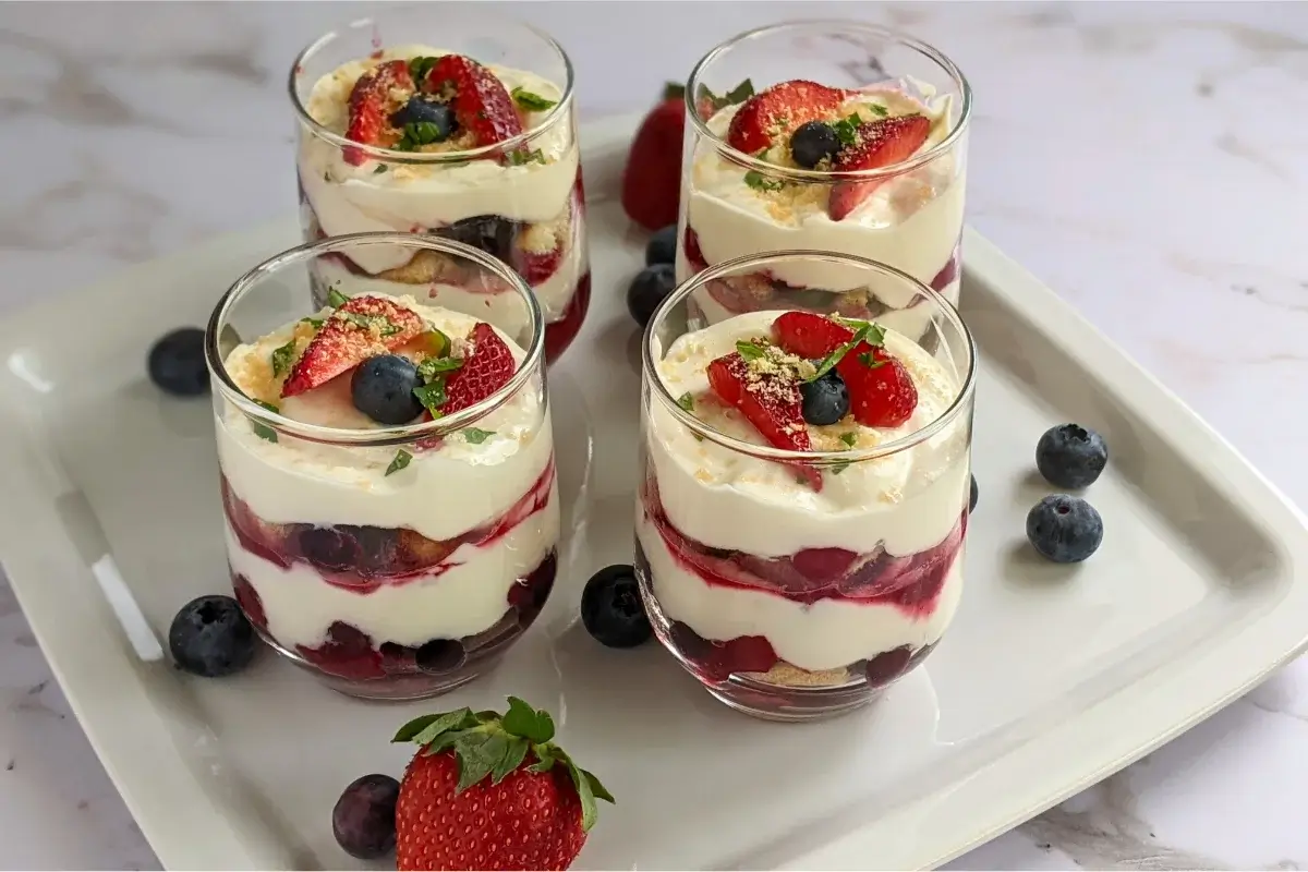 Healthier take on tiramisu made with mascarpone, Greek yogurt, ladyfingers, and a sweet mixed berry compote.