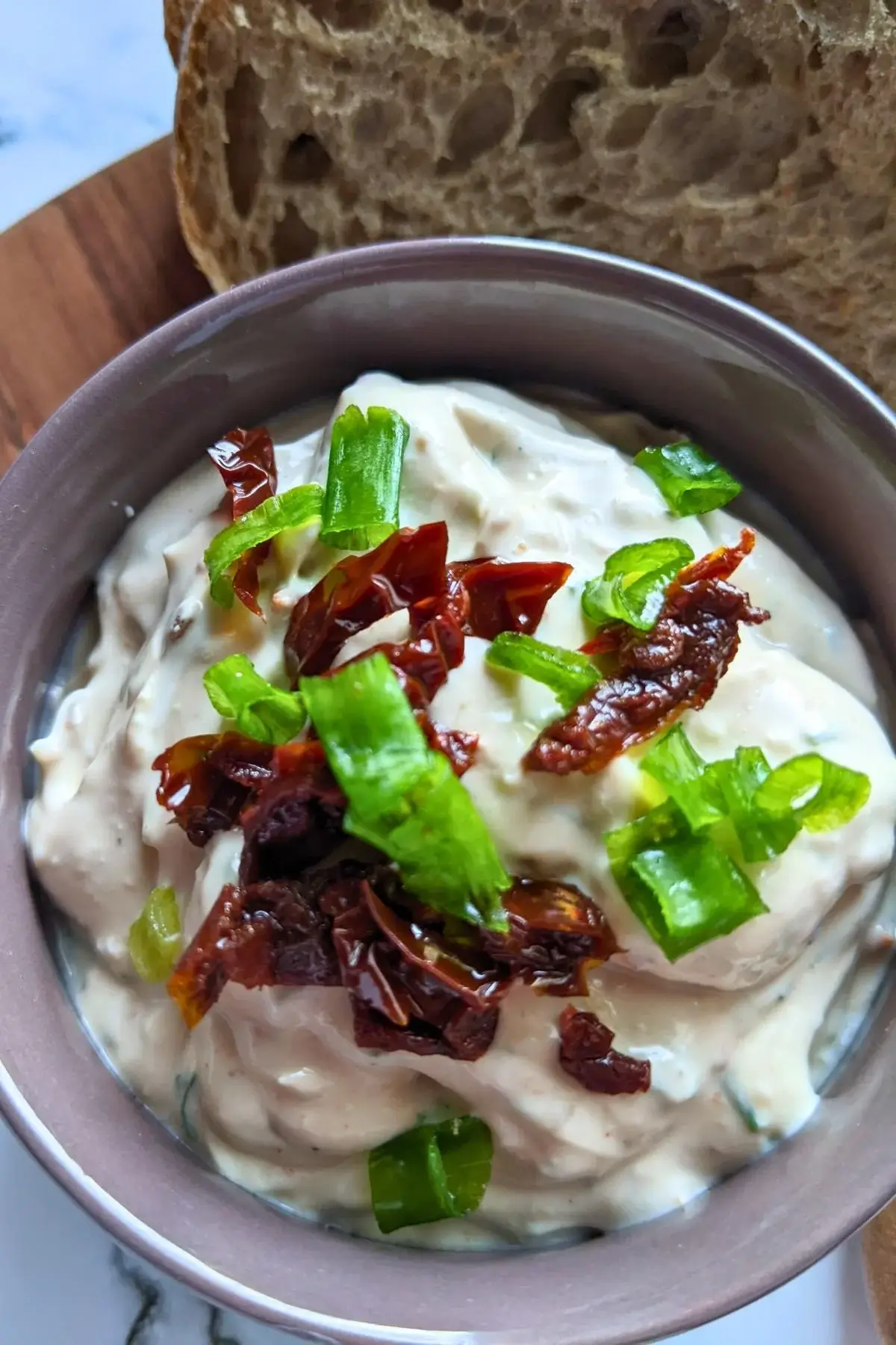 Creamy feta spread blended with sundried tomatoes and herbs, perfect for crackers or fresh bread.