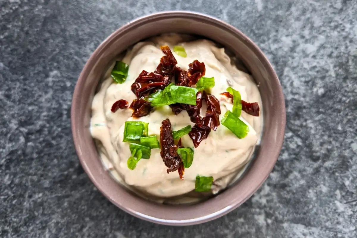 Creamy feta spread blended with sundried tomatoes and herbs, perfect for crackers or fresh bread.