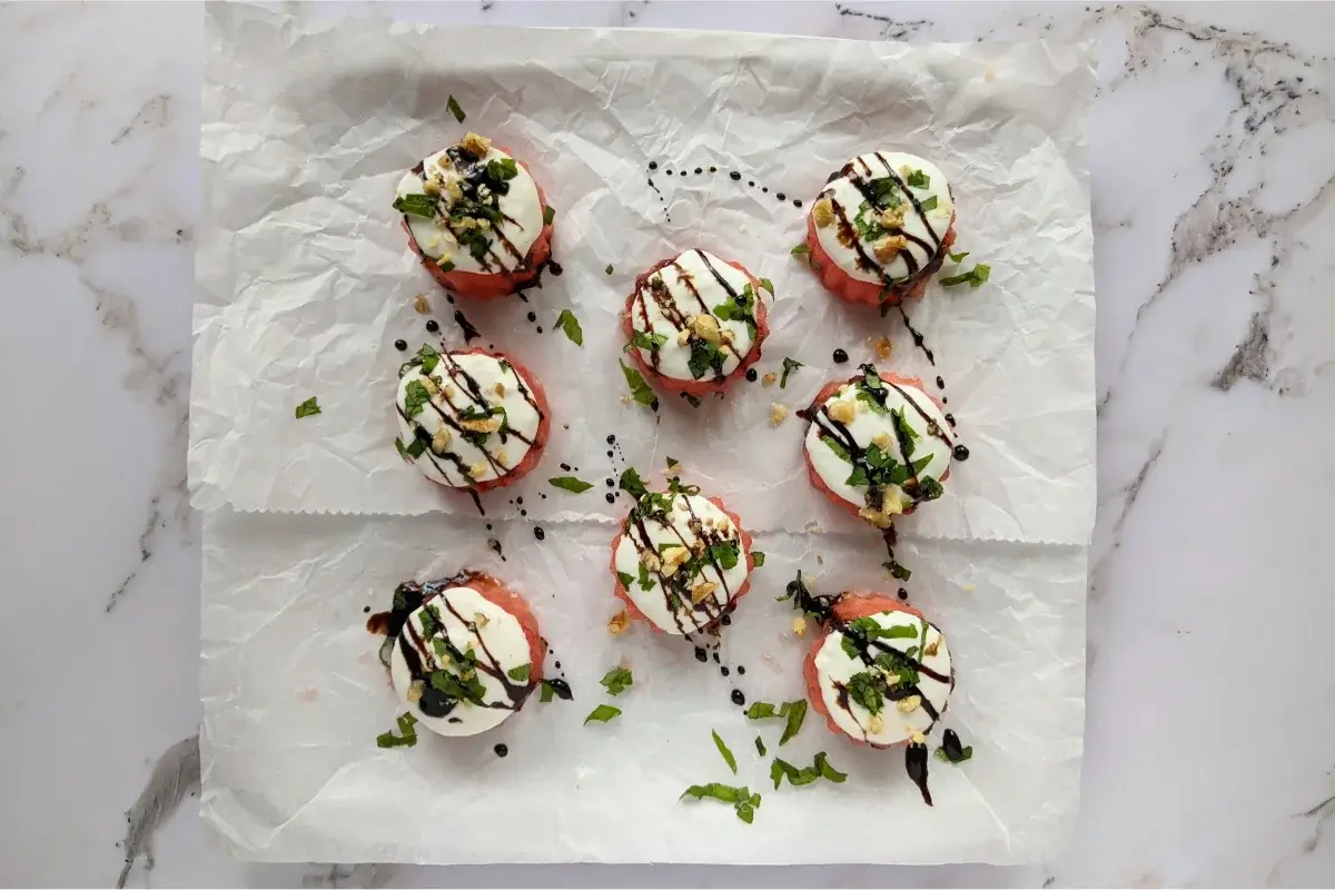 Juicy watermelon rounds topped with creamy goat cheese and fresh herbs for a flavorful contrast.