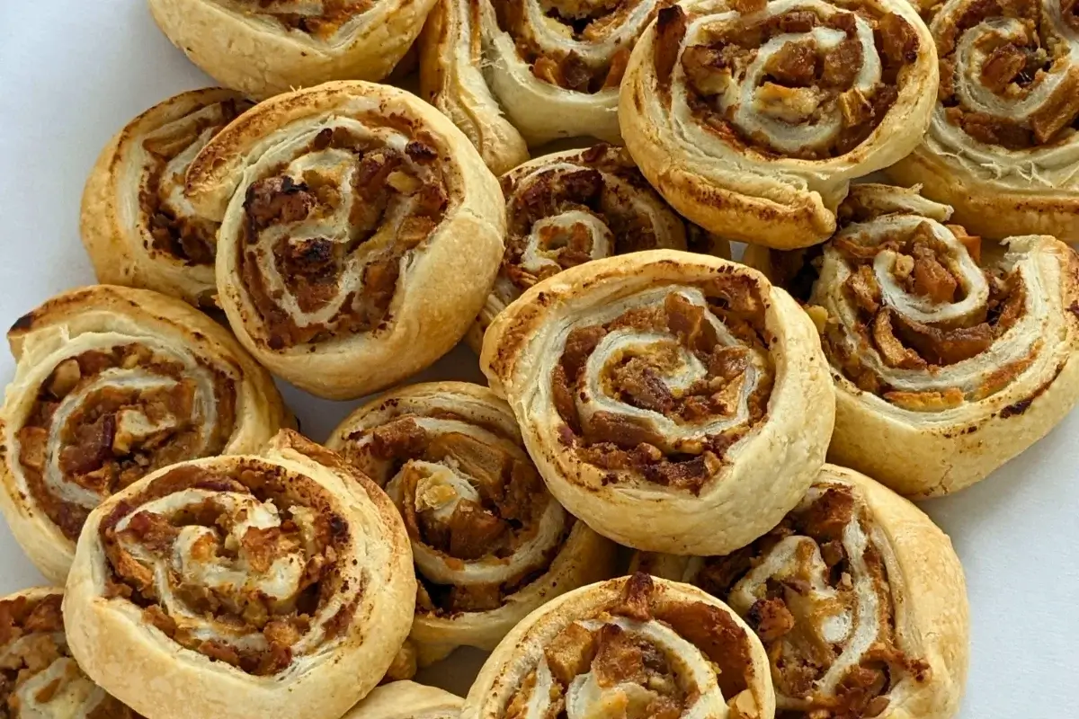 Rolled puff pastry filled with ricotta, cinnamon apples, and walnuts.