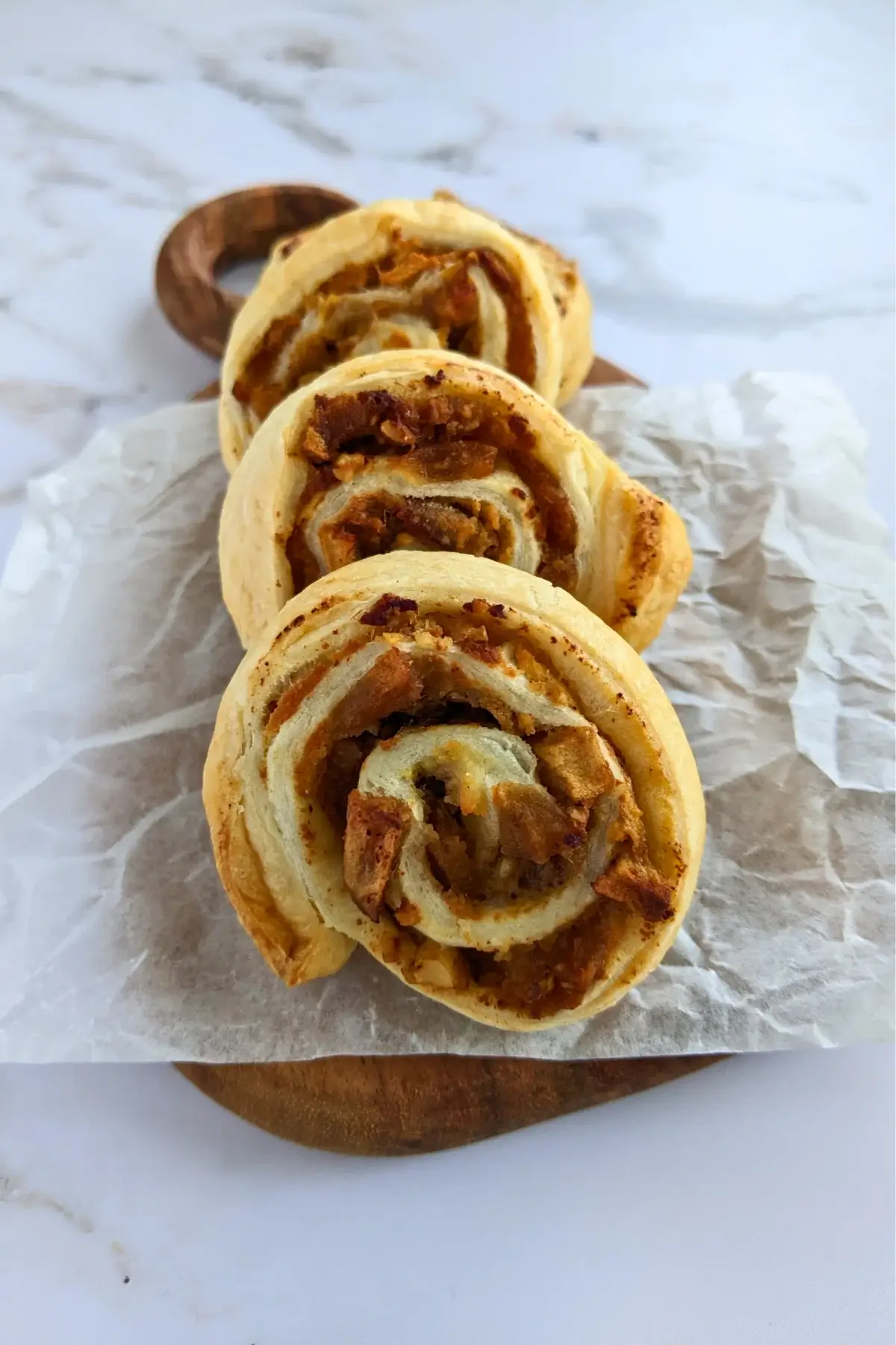Rolled puff pastry filled with ricotta, cinnamon apples, and walnuts.