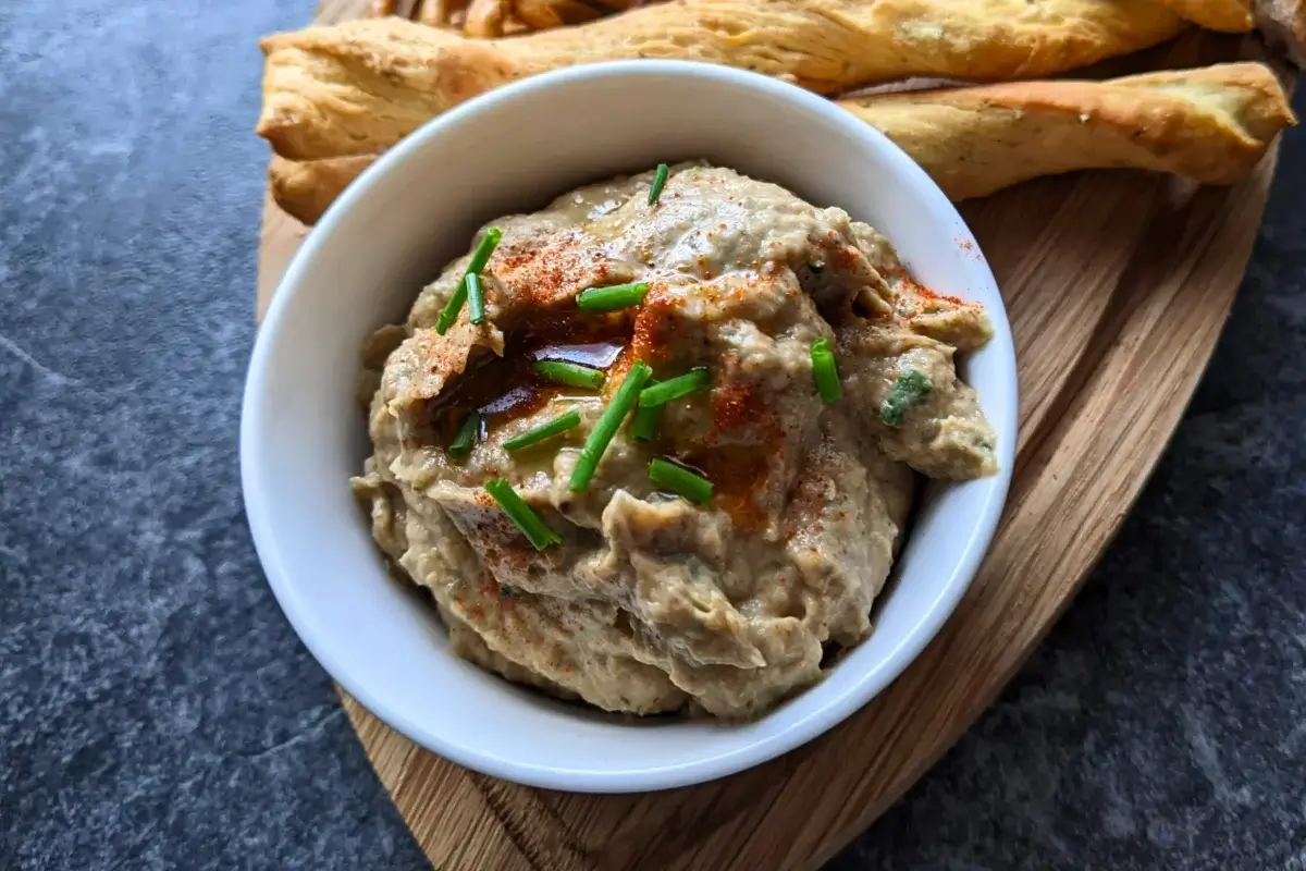 Creamy baba ganoush, a roasted eggplant dip blended with tahini, lemon juice, and garlic.