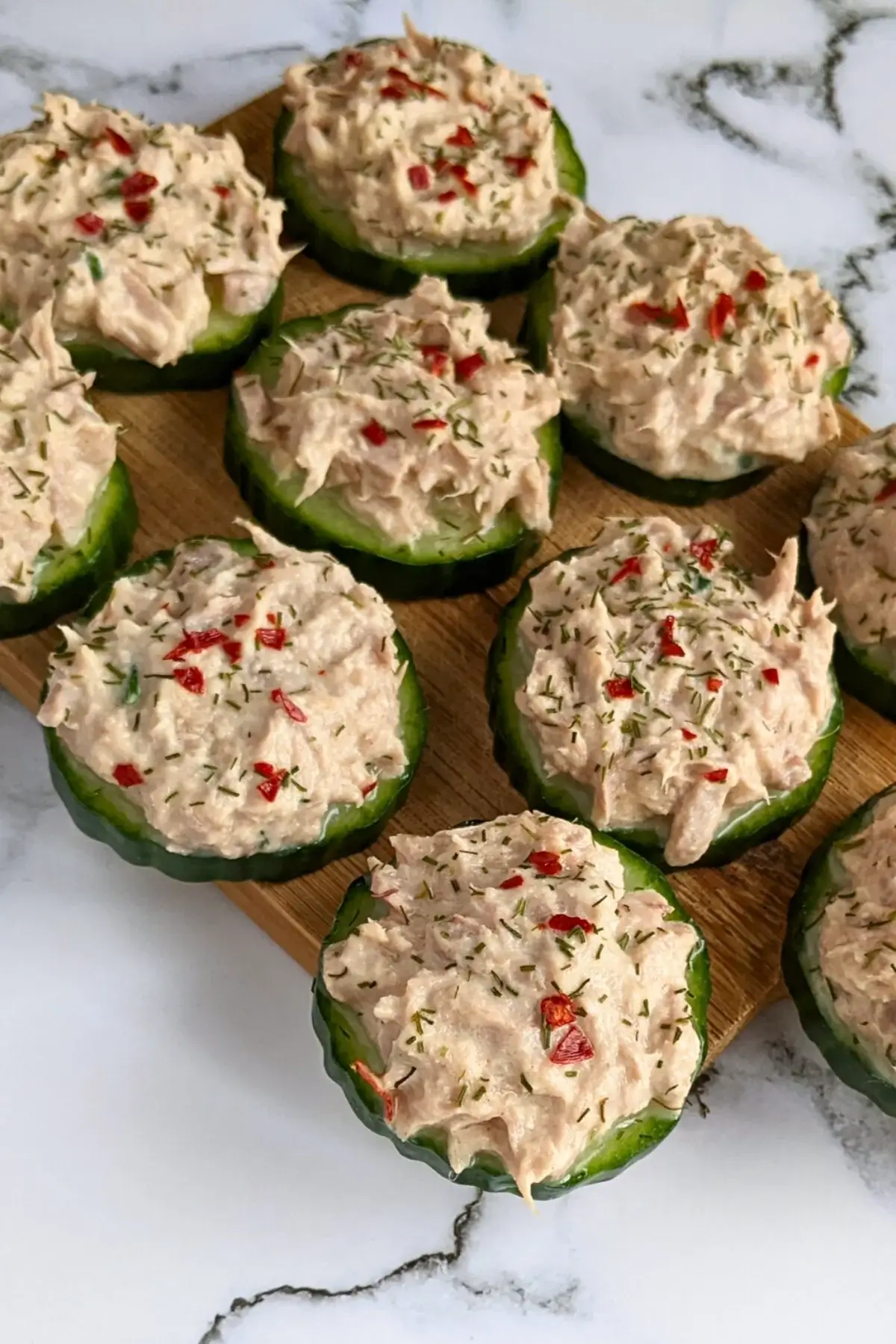 Spicy tuna cucumber bites made with sliced cucumber topped with a light tuna salad mixture.
