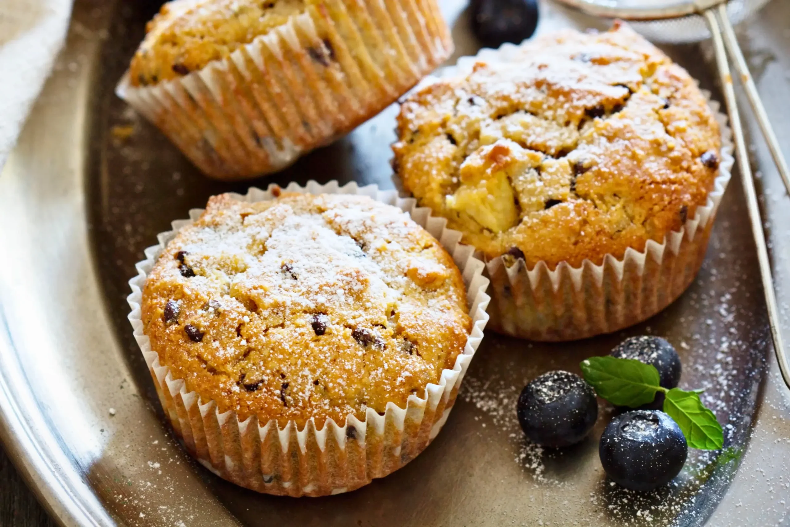 Moist apple muffins made with almond flour, showing a chewy, golden texture.