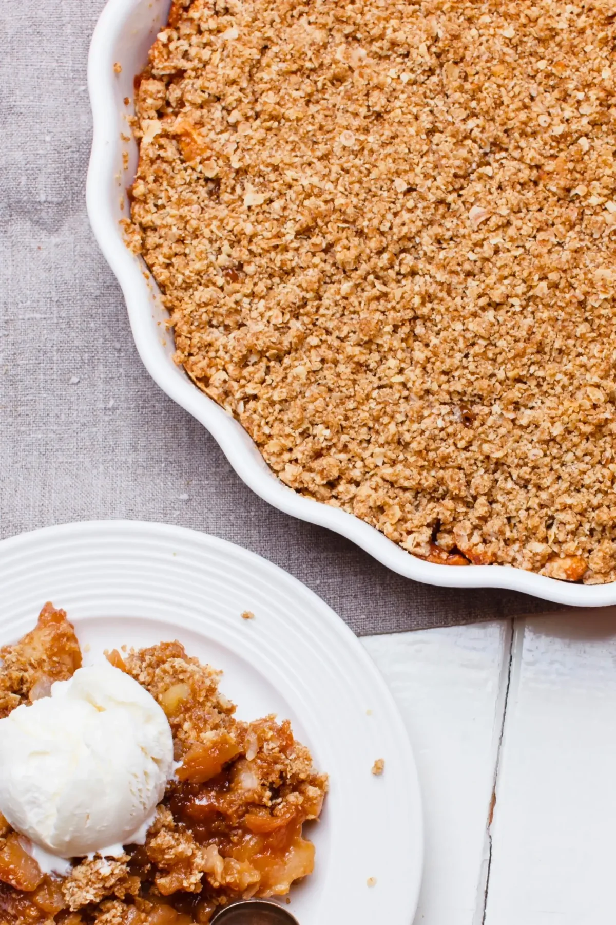 Fruit-filled crumble with a golden, crumbly topping and chunks of rhubarb and apple at the bottom.