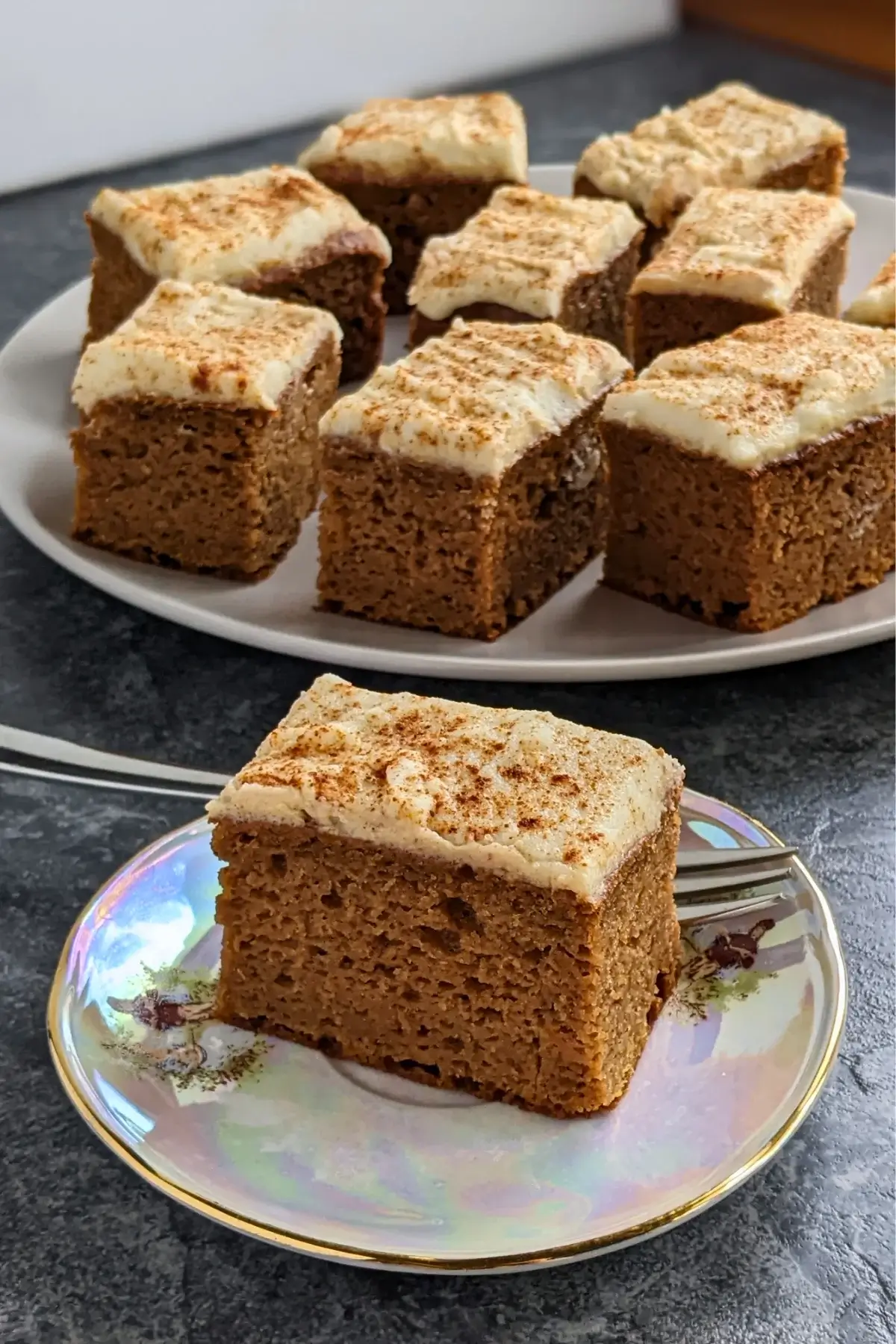 Pumpkin spice bars made with applesauce and topped with light, sugar-free frosting.