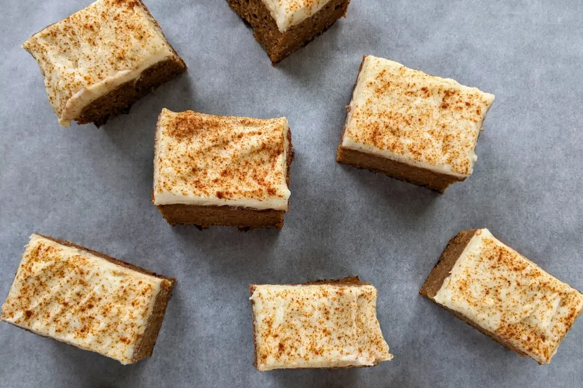 Pumpkin spice bars made with applesauce and topped with light, sugar-free frosting.