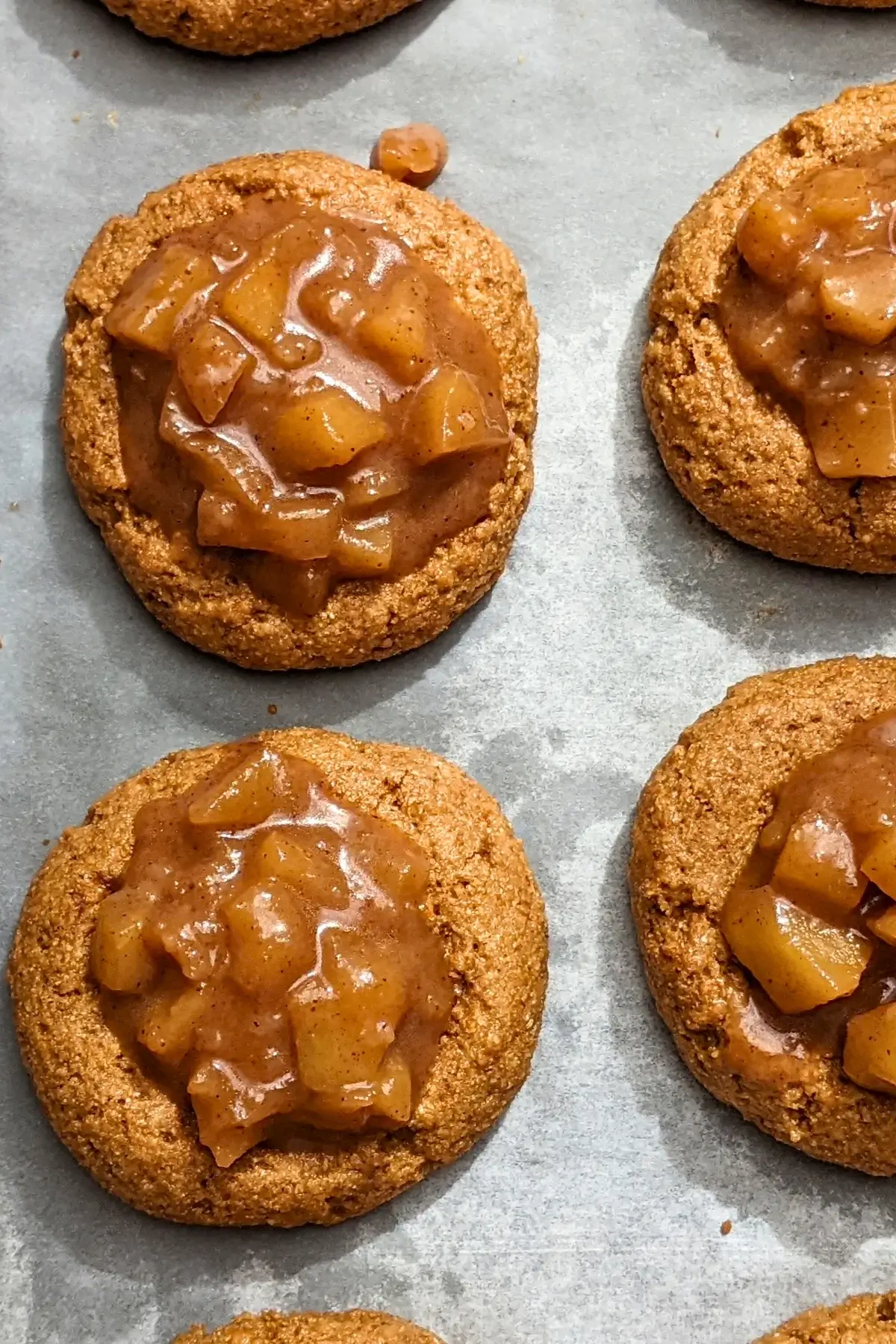 Apple pie thumbprint cookies - cookies made with wholemeal flour and coconut sugar, filled with a cinnamon apple pie filling and topped with a simple powdered sugar/milk icing.