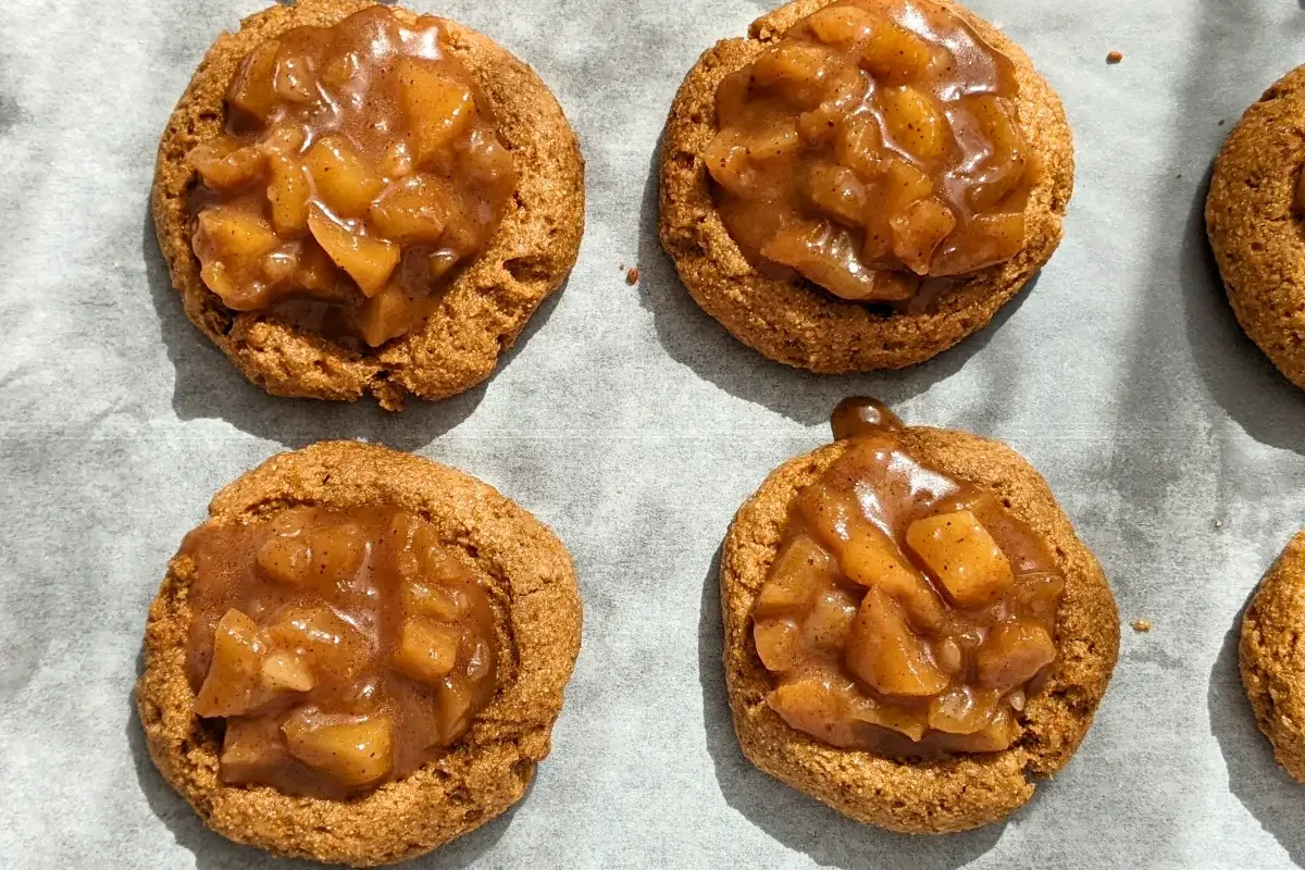 Apple pie thumbprint cookies - cookies made with wholemeal flour and coconut sugar, filled with a cinnamon apple pie filling and topped with a simple powdered sugar/milk icing.