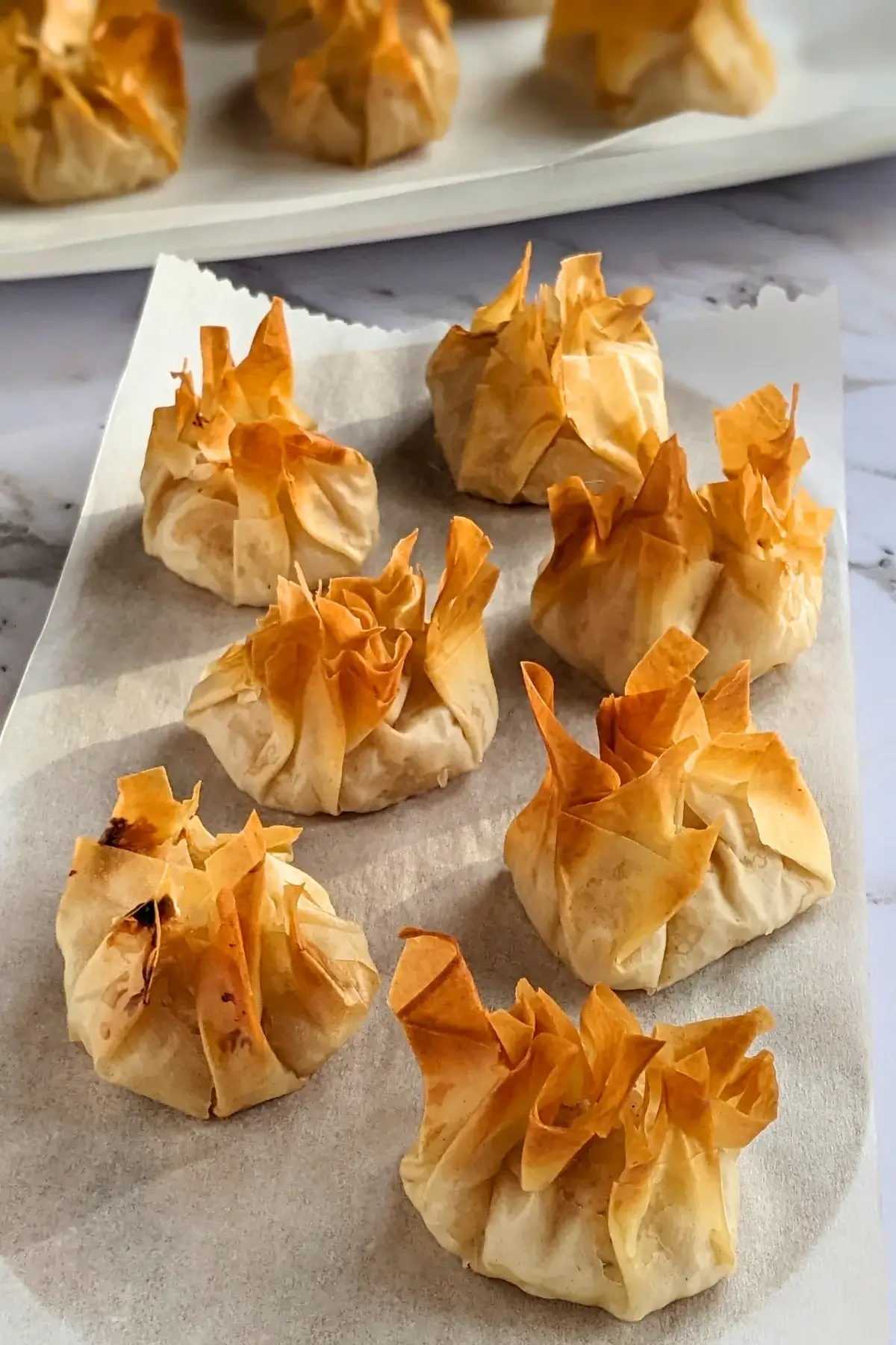 Phyllo pastry parcels filled with creamy ricotta and applesauce, baked until golden and crisp.