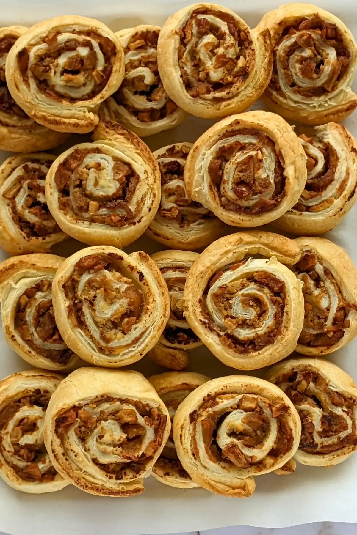 Rolled puff pastry filled with ricotta, cinnamon apples, and walnuts.
