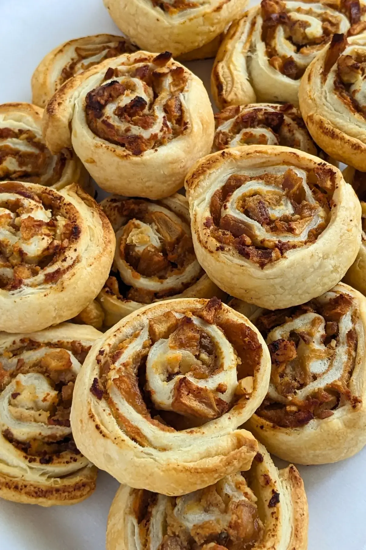 Rolled puff pastry filled with ricotta, cinnamon apples, and walnuts.