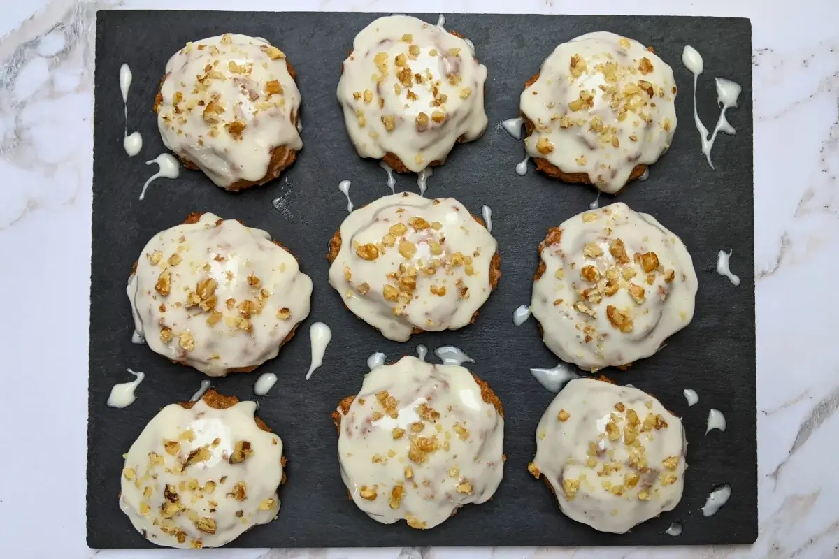 Applesauce cookies with cream cheese frosting - healthier fall cookies made with applesauce, wholemeal flour, and a mix of white and coconut sugar, topped with a cream cheese frosting and crushed walnuts.