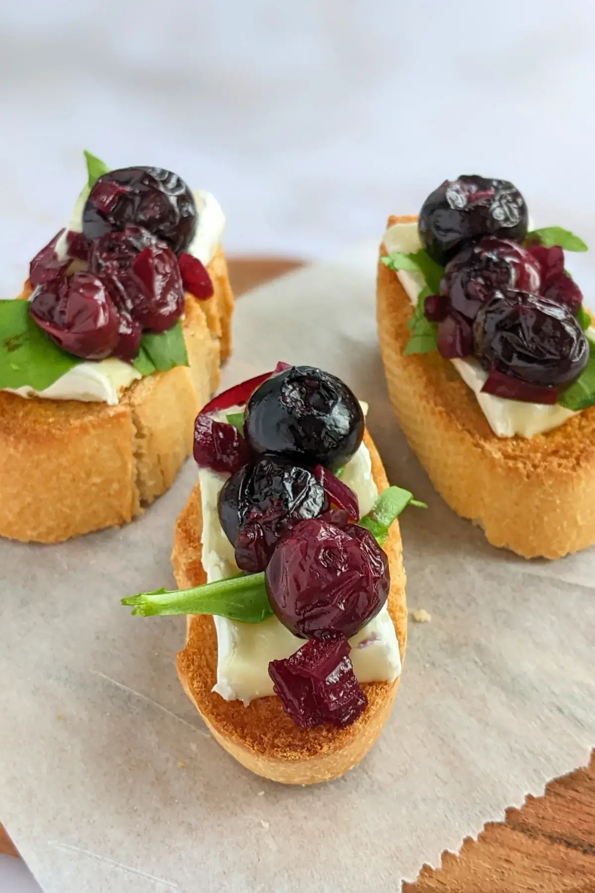 Blueberry crostini with Brie & arugula, layered with balsamic blueberries and arugula on toasted baguette slices.