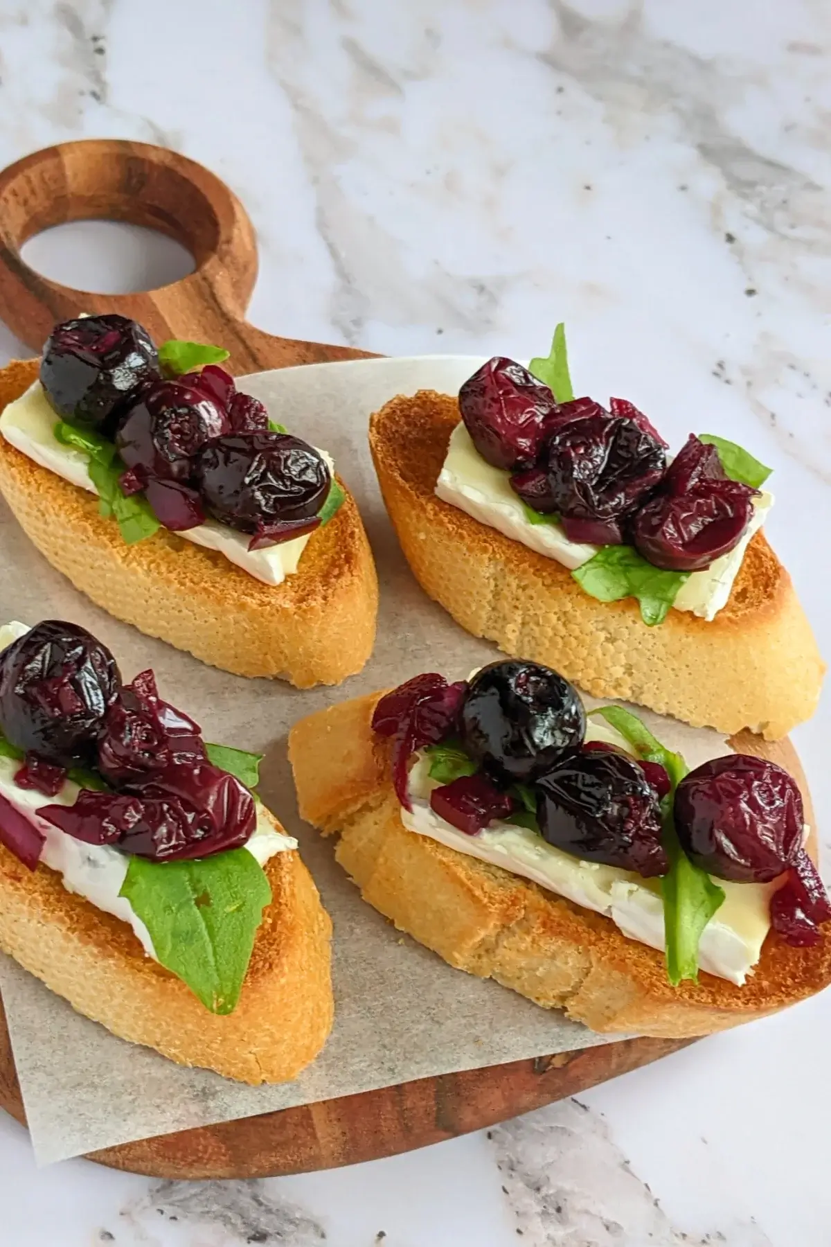 Blueberry crostini with Brie & arugula, layered with balsamic blueberries and arugula on toasted baguette slices.