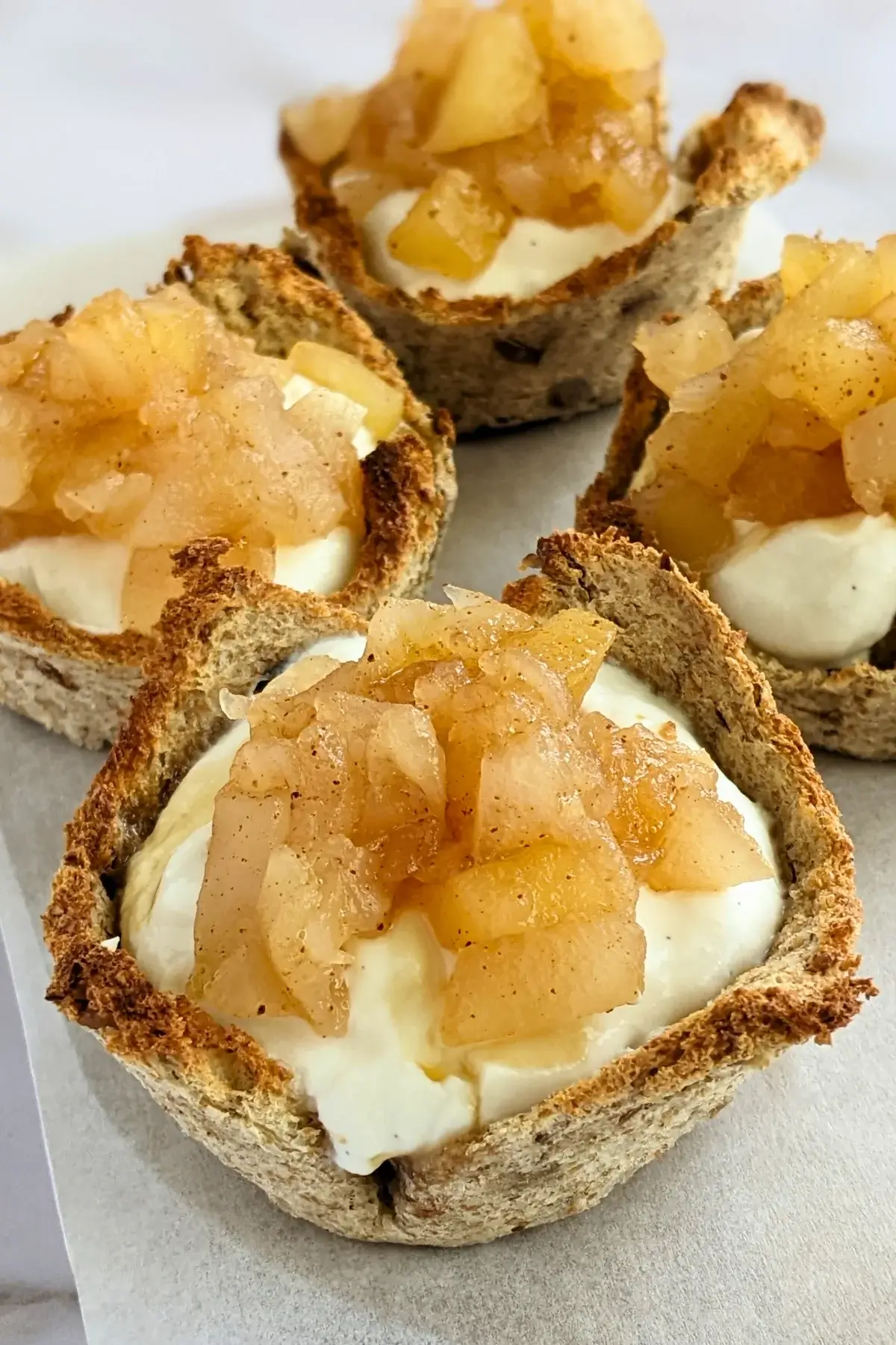 Wholemeal bread cups filled with whipped ricotta and topped with homemade applesauce.
