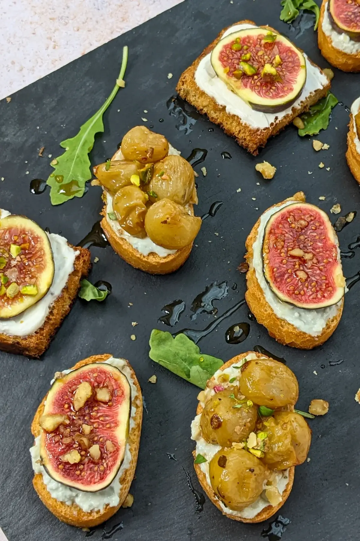 Cheese and Fruits Crostini Appetizers Platter - Italian crostini party food platter with cheese and fruit toppings.