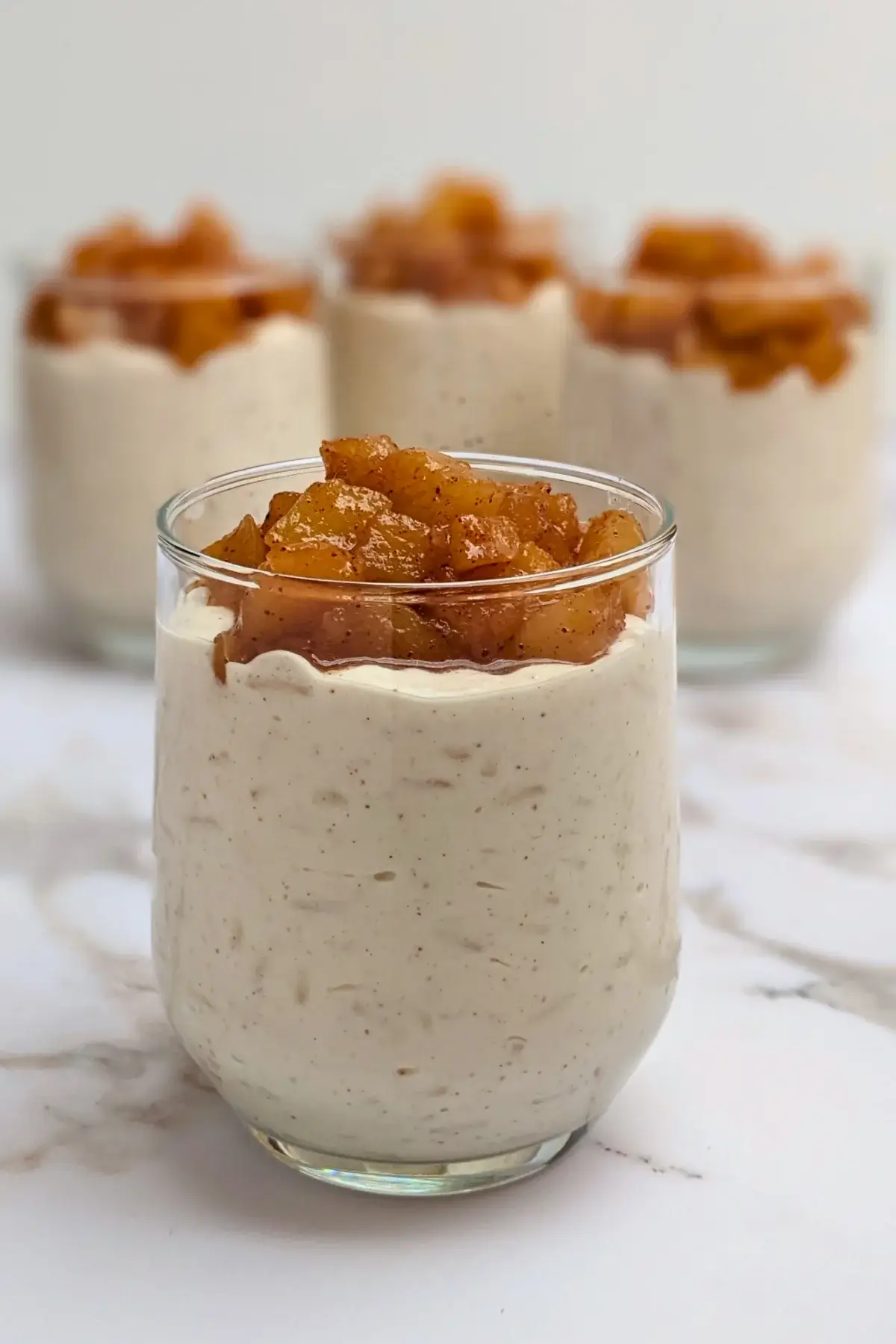 Cinnamon apple rice pudding - rice pudding dessert made with cooked rice and a whipped cream and ricotta blend, topped with cinnamon butter apple pie filling.