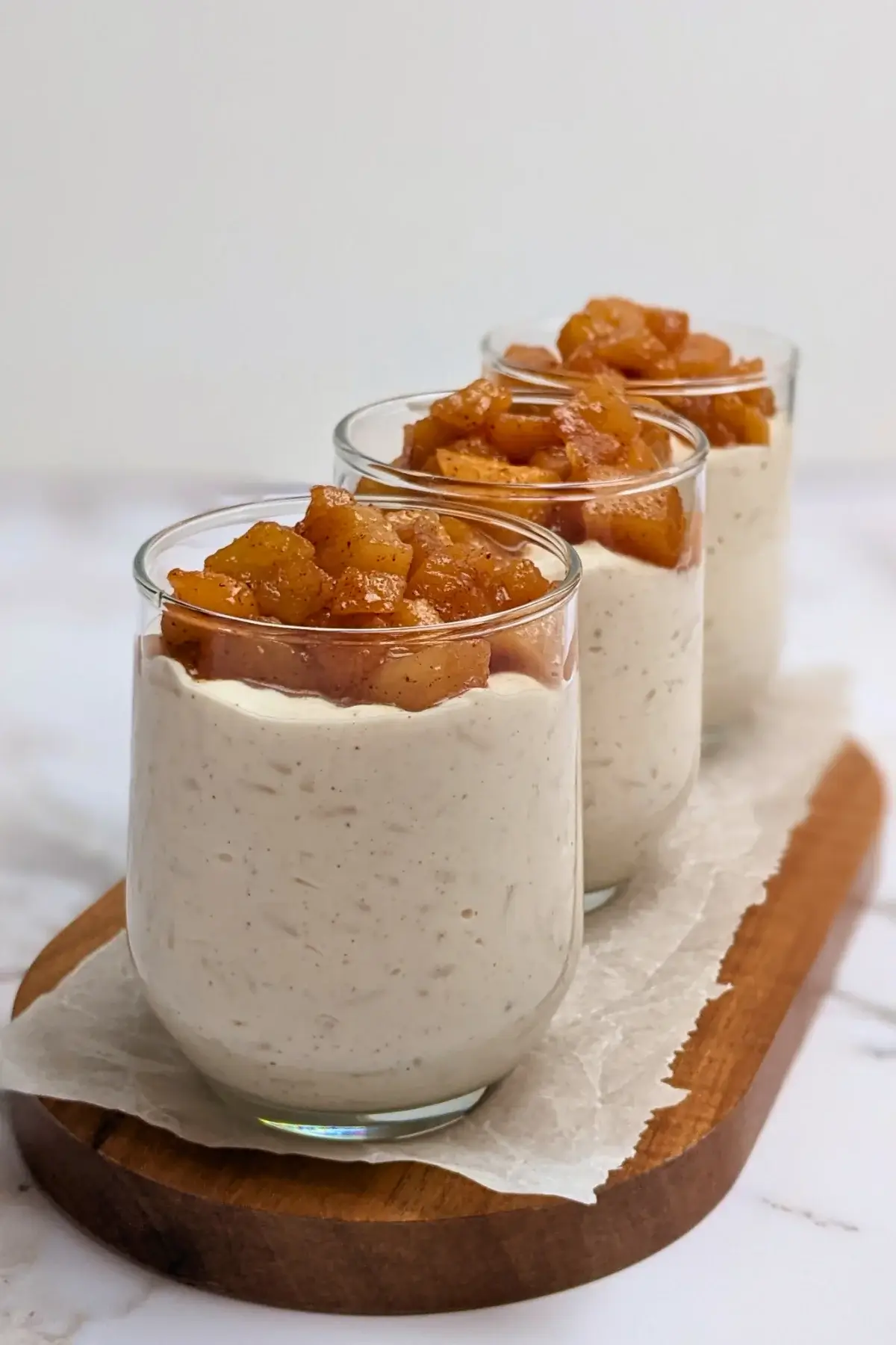 Cinnamon apple rice pudding - rice pudding dessert made with cooked rice and a whipped cream and ricotta blend, topped with cinnamon butter apple pie filling.