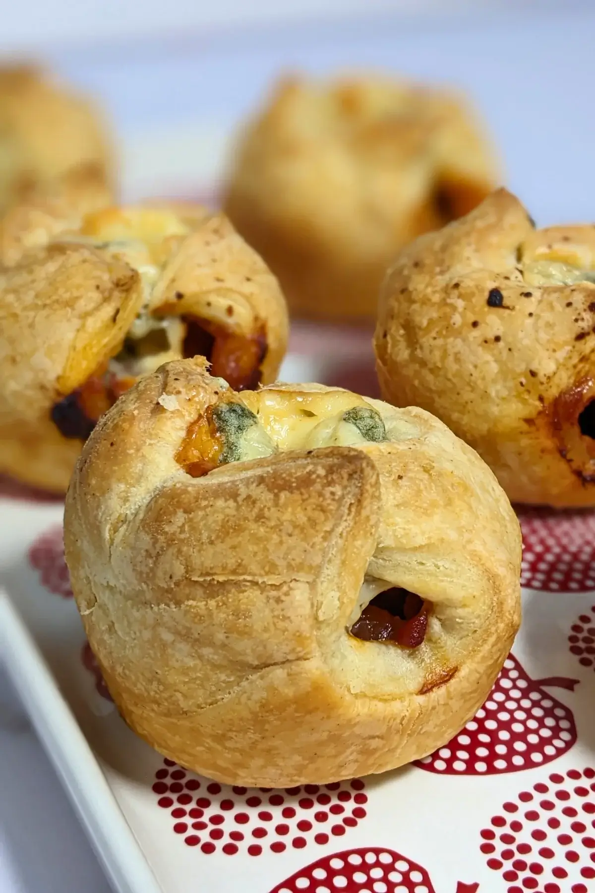 Prosciutto and blue cheese puff pastry appetizers - savory puff pastry cups filled with sweet chili sauce, prosciutto and blue cheese.