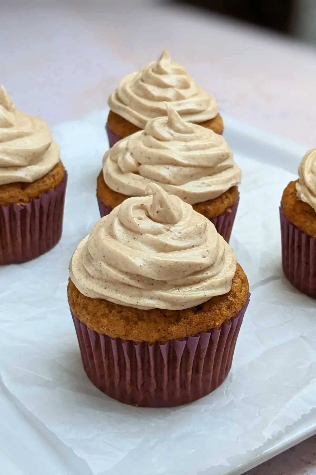 Pumpkin Cheesecake Cupcakes with Cinnamon Cream Cheese Icing - pumpkin cupcakes with a cheesecake filling and cinnamon cream cheese frosting.