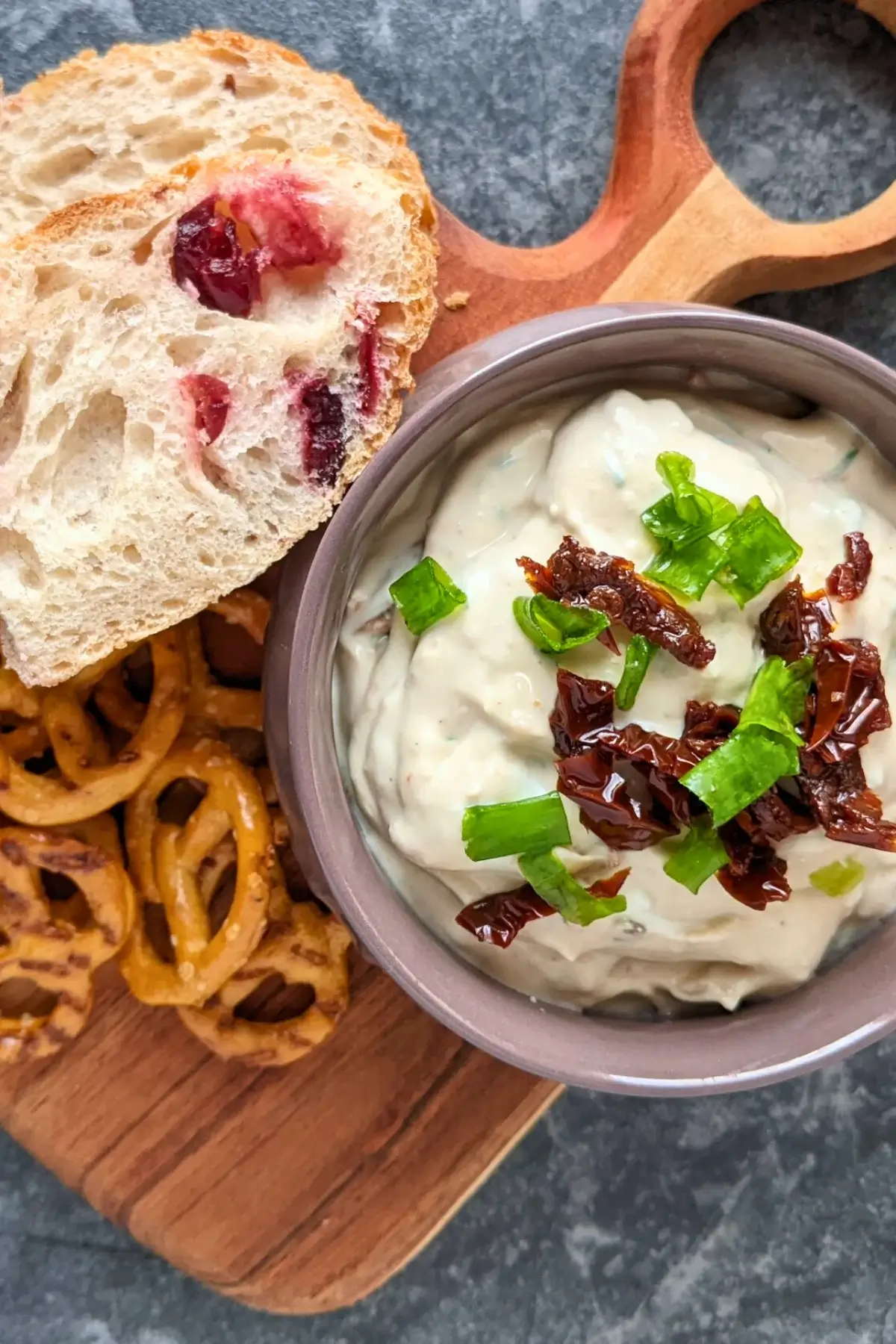 Creamy feta and sundried tomato dip served with bread slices and puff pastry sticks.