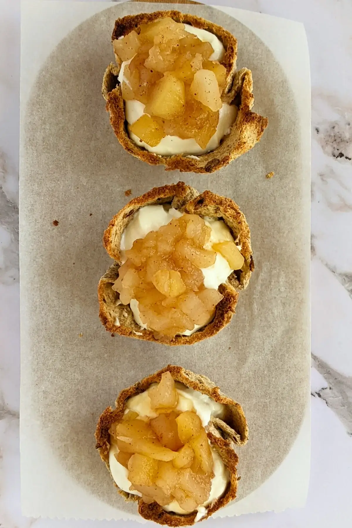 Toasted bread cups filled with creamy ricotta and topped with homemade cinnamon-spiced applesauce.